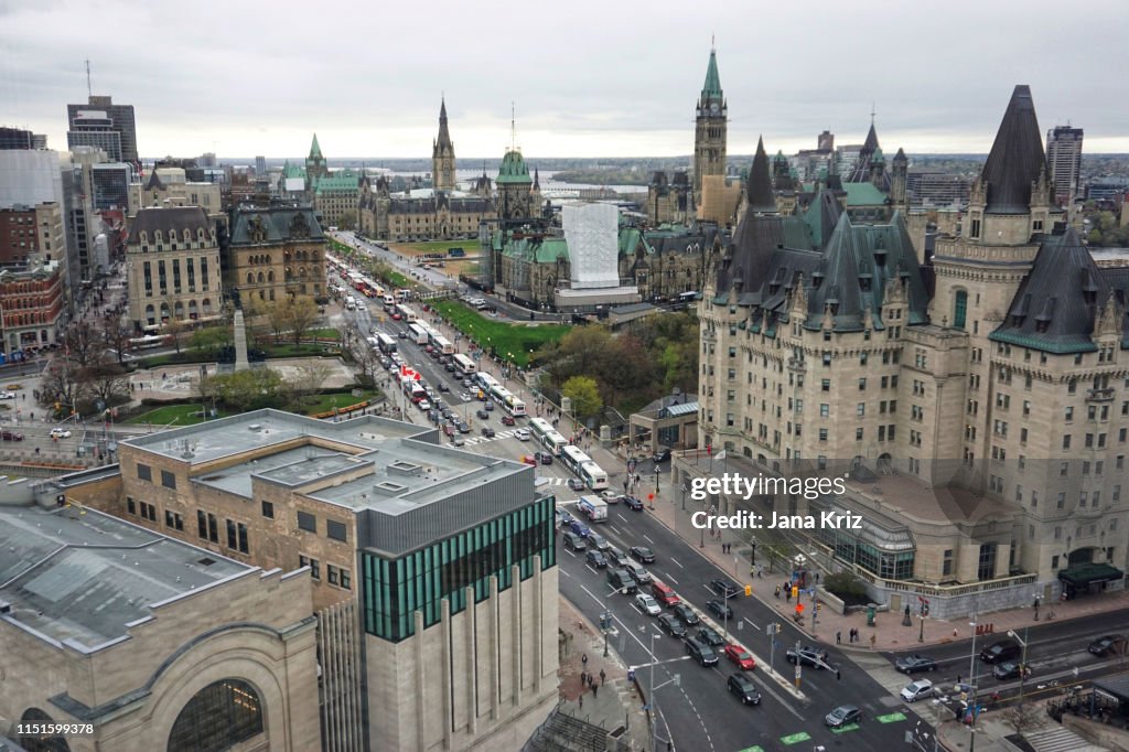 Downtown Ottawa in the spring viewed from high up. Aerial view of Chateau Laurier and Canadian Parliament. Traffic on Wellington