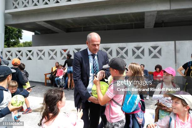 Director of Roland Garros tournament, Guy Forget signs autographs during the 2019 French Tennis Open - Kids Day at Roland Garros on May 25, 2019 in...