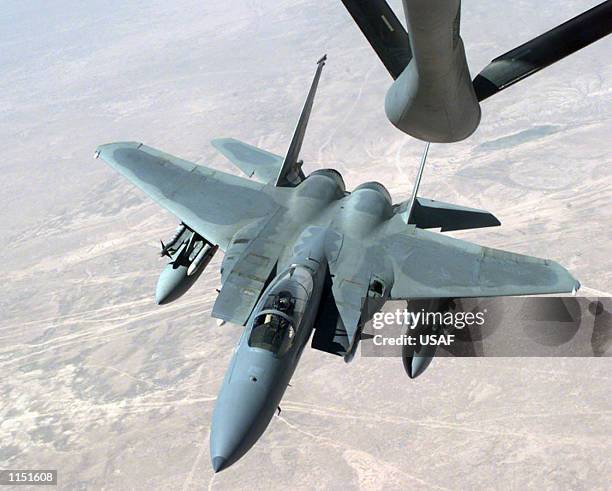 An Air Force F-15Cs from the Pacific Air Forces pulls into position beneath a KC-135 Strato-tanker to refuel while flying near the Iraqi border...
