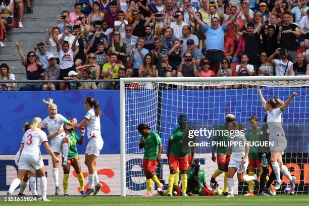 England's defender Steph Houghton is congratulated by teammates after scoring a goal during the France 2019 Women's World Cup round of sixteen...