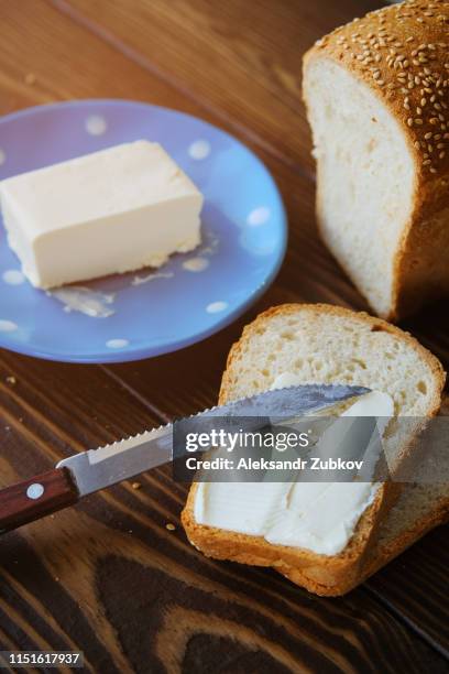 bread with sesame and butter on a rustic wooden table. making toast and sandwiches for breakfast or lunch. the concept of organic healthy food. copy space. - margarine photos et images de collection