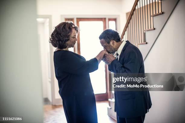 Senior couple embracing in hallway of their home