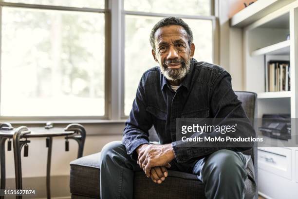 portrait of senior man at home - african ethnicity stock pictures, royalty-free photos & images