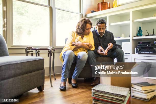 Senior couple packing books to move