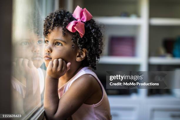 portrait of preschool age girl looking out window - fantasy portrait bildbanksfoton och bilder