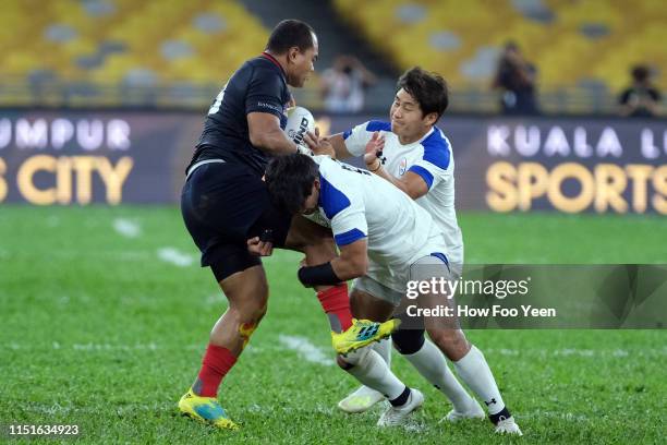 Mohd Syahir Asraf Rosli of Malaysia and Yongun Lee , Jisu Park of South Korea in action during the Asia Rugby Championship match between Malaysia and...