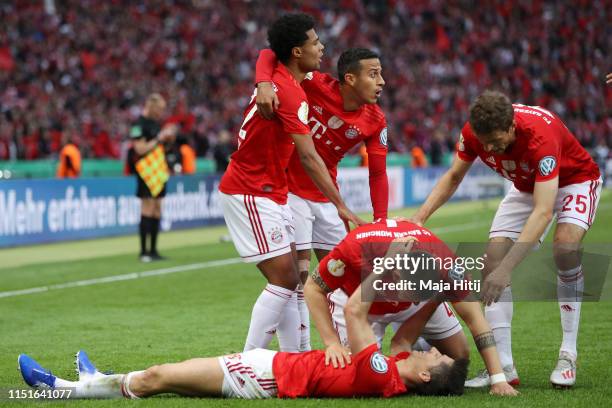 Robert Lewandowski of Bayern Munich celebrates with teammates after scoring his team's first goal during the DFB Cup final between RB Leipzig and...