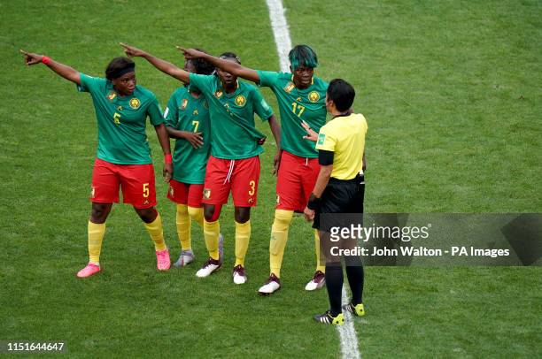 Cameroon's Augustine Ejangue , Gabrielle Aboudi Onguene , Ajara Nchout and Gaelle Enganamouit appeal to match referee Qin Liang after England's...