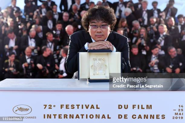 Director Bong Joon-Ho, winner of the Palme d'Or award for his film "Parasite" poses at the winner photocall during the 72nd annual Cannes Film...