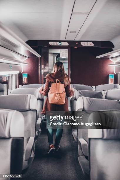 young woman walking among the seats on tgv train, paris, france, europe - tgv 個照片及圖片檔