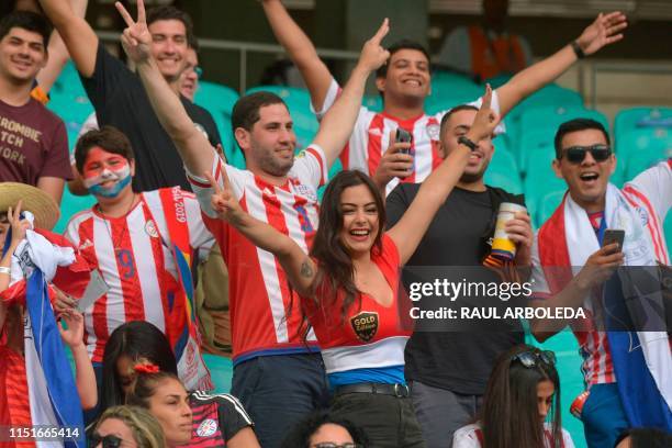 Fans of Paraguay, including model Larissa Riquelme , cheer before the start of the Copa America football tournament group match against Colombia at...