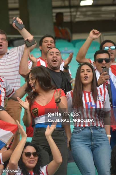 Fans of Paraguay, including model Larissa Riquelme , cheer before the start of the Copa America football tournament group match against Colombia at...