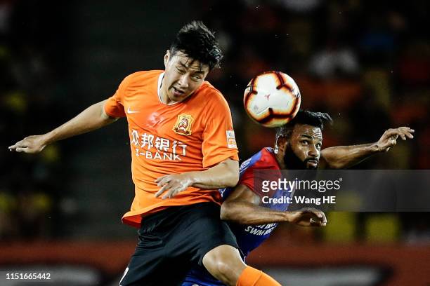 Liao Junjian of Wuhan Zall header and Fernandinho of Chongqing SWM Motors during 2019 China Super League at Wuhan Wuhuan Sports Center on June 23,...