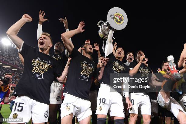 Valencia CF players celebrate with the trophy at the end of the Spanish Copa del Rey match between Barcelona and Valencia at Estadio Benito...