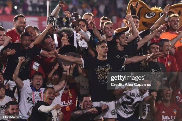 Valencia CF players celebrate with the trophy at the end of the Spanish Copa del Rey match between Barcelona and Valencia at Estadio Benito...