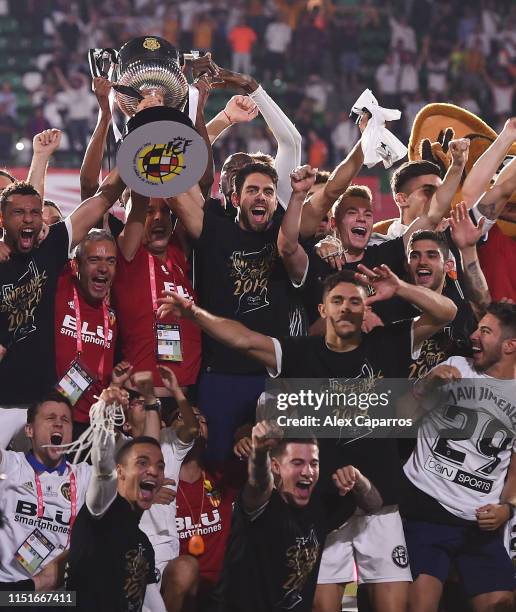 Valencia CF players celebrate with the trophy at the end of the Spanish Copa del Rey match between Barcelona and Valencia at Estadio Benito...