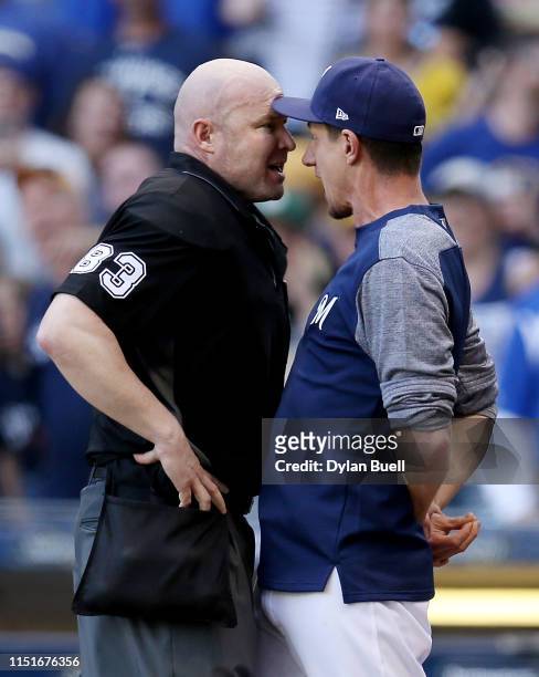 Manager Craig Counsell of the Milwaukee Brewers argues with umpire Mike Estabrook in the eighth inning against the Philadelphia Phillies at Miller...