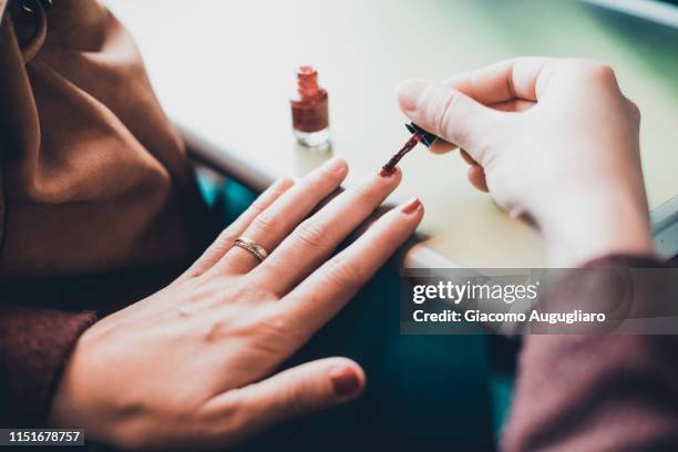 young woman painting her fingernails on tgv train, paris, france, europe - french manicure stockfoto's en -beelden