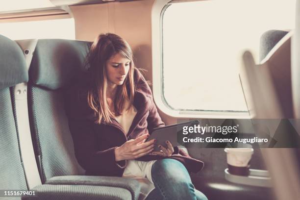 young woman watching her tablet on tgv train, paris, france, europe - tgv 個照片及圖片檔