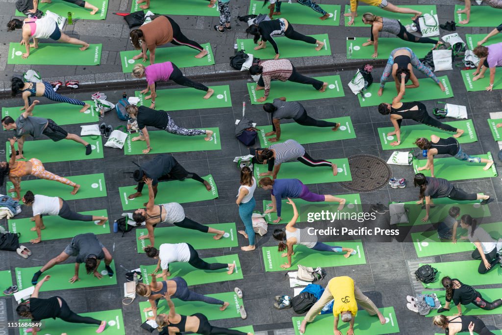 Hundreds yoga enthusiasts participate in mass yoga class on...