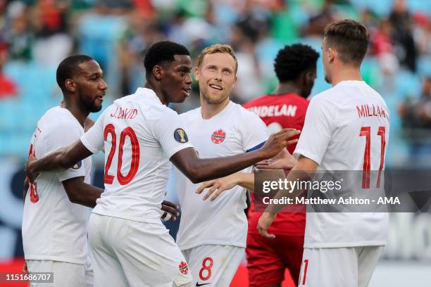 Jonathan David of Canada celebrates after scoring a goal to make it 7-0 during the Group A 2019 CONCACAF Gold Cup match between Canada v Cuba at Bank...