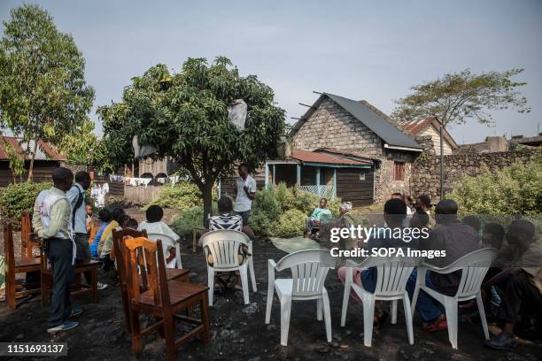 Locals attend a community meeting aimed at educating them about the symptoms and treatment of Ebola in Goma. DR Congo is currently experiencing the...