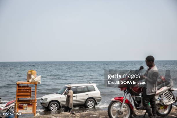 Vehicle and a motorcycle at the shores of Lake Kivu in Goma. DR Congo is currently experiencing the second worst Ebola outbreak in recorded history....