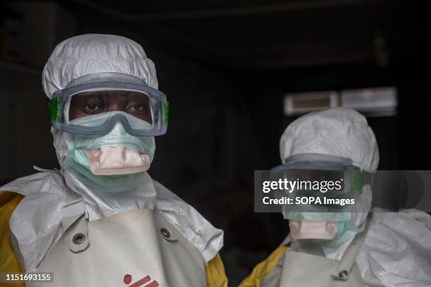 Medical staff dressed in protective gear before entering an isolation area at an Ebola treatment centre in Goma. DR Congo is currently experiencing...