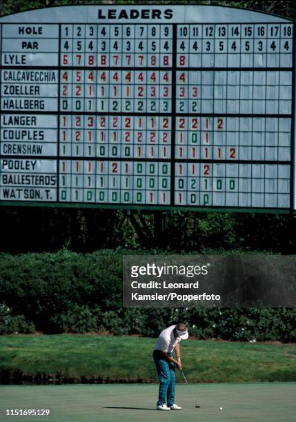 Scottish golfer Sandy Lyle putting under the leaderboard enroute to winning the US Masters Golf Tournament at the Augusta National Golf Club in...