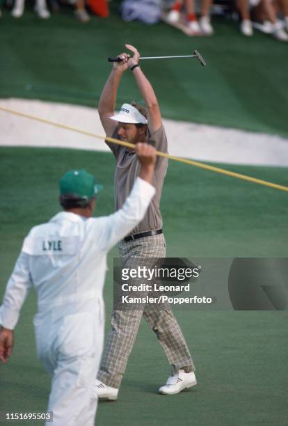 Scottish golfer Sandy Lyle celebrates with his caddy Dave Musgrove after winning the US Masters Golf Tournament at the Augusta National Golf Club in...