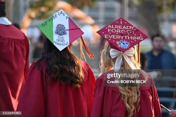 Graduating students at Pasadena City College wear decorated academic caps at the school's graduation ceremony, June 14 in Pasadena, California. -...