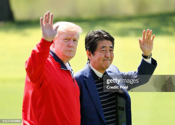 President Donald Trump and Japanese Prime Minister Shinzo Abe wave on the way to play golf at Mobara Country Club on May 26, 2019 in Chiba, Japan....