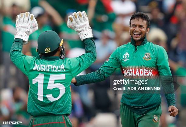 Bangladesh's Shakib Al Hasan celebrates with teammate Mushfiqur Rahim after the dismissal of Afghanistan's Najibullah Zadran during the 2019 Cricket...