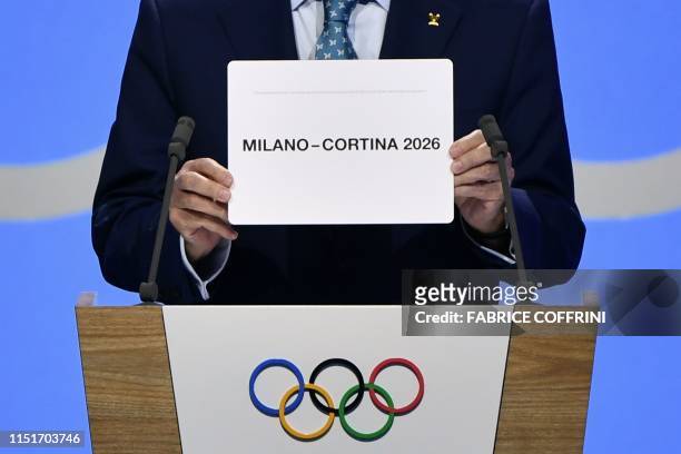 International Olympic Committee president Thomas Bach shows the card with the name Milan/Cortina d'Ampezzo as the winning name of the 2026 Winter...
