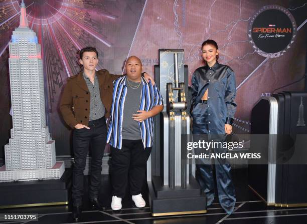 Cast members Tom Holland, Jacob Batalon and Zendaya of "Spider-Man: Far From Home" participate in the ceremonial lighting of the Empire State...