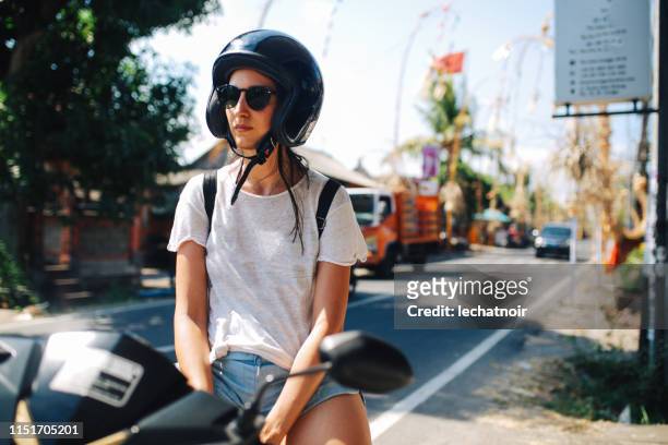solo traveler woman riding a motorcycle in bali, indonesia - indonesia bikes traffic stock pictures, royalty-free photos & images