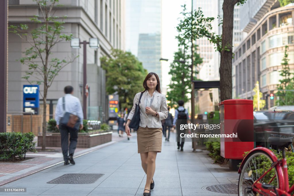 Businesswoman walking on street