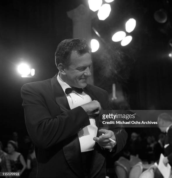 Actor James Arness of TV's 'Gunsmoke' lights one up at the 9th Primetime Emmy Awards held at NBC's Burbank Studios on March 16, 1957 in Los Angeles,...