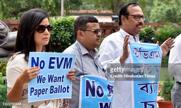 All India Trinamool Congress MPs hold placards during a protest in resistance to the use of Electronic Voting Machines in elections, in front of...