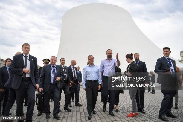 French Prime minister Edouard Philippe and his Russian homolog Dimitri Medvedev arrive to visit the Oscar Niemeyer library during an official visit...