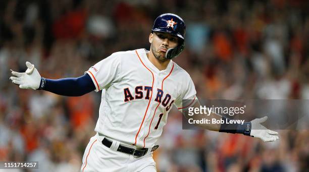Carlos Correa of the Houston Astros celebrates after hitting a walk off single in the ninth inning against the Boston Red Sox at Minute Maid Park on...