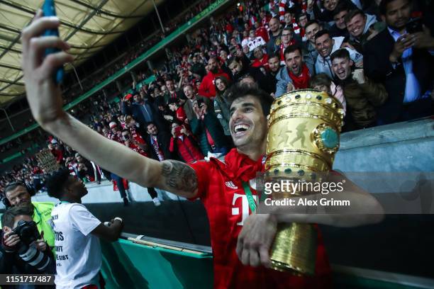 Javi Martinez of Bayern Munich poses with the DFB Pokal following his team's victory in the DFB Cup final between RB Leipzig and Bayern Muenchen at...