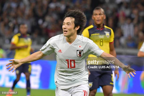 Japan's Shoya Nakajima celebrates after scoring against Ecuador during their Copa America football tournament group match at the Mineirao Stadium in...