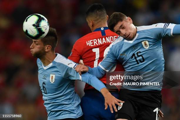 Uruguay's Rodrigo Bentancur and Federico Valverde vie for the ball with Chile's Pedro Pablo Hernandez during their Copa America football tournament...