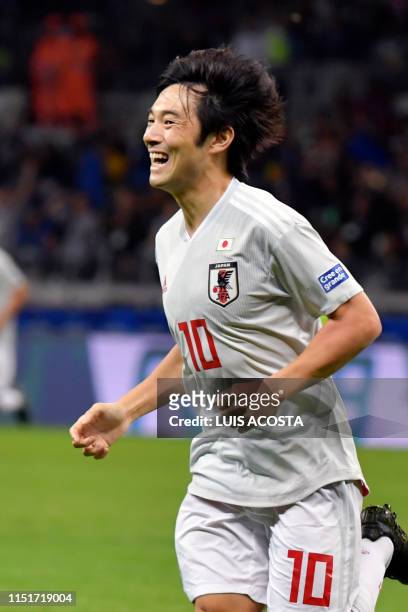 Japan's Shoya Nakajima celebrates after scoring against Ecuador during their Copa America football tournament group match at the Mineirao Stadium in...