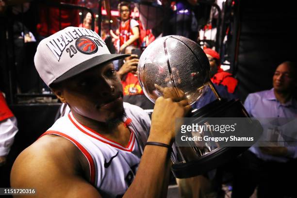 Kyle Lowry of the Toronto Raptors walks off the court with the Eastern Conference Finals trophy after defeating the Milwaukee Bucks 100-94 in game...