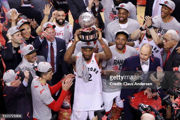 Kawhi Leonard of the Toronto Raptors celebrates with the Eastern Conference Finals trophy after defeating the Milwaukee Bucks 100-94 in game six of...