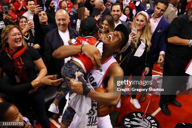 Kyle Lowry of the Toronto Raptors celebrates with his sons Kameron and Karter after defeating the Milwaukee Bucks 100-94 in game six of the NBA...