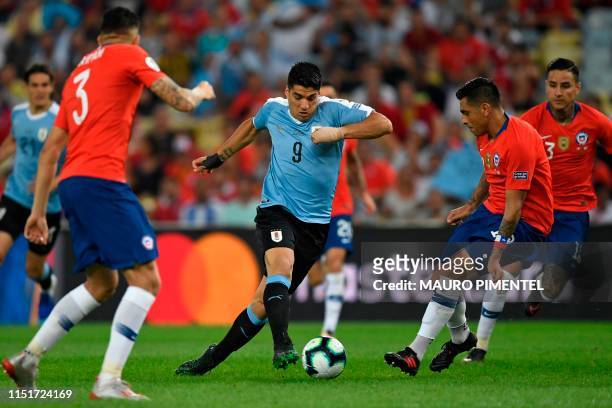 Uruguay's Luis Suarez is marked by Chile's Gonzalo Jara during their Copa America football tournament group match at Maracana Stadium in Rio de...