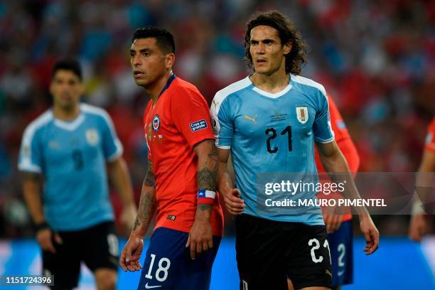 Chile's Gonzalo Jara and Uruguay's Edinson Cavani are pictured during their Copa America football tournament group match at Maracana Stadium in Rio...